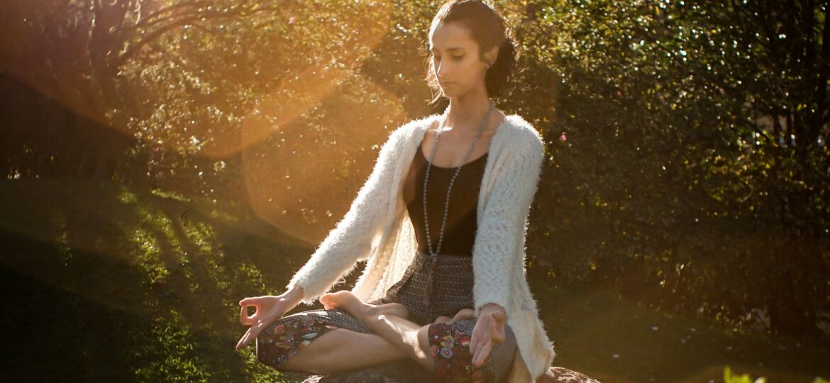woman-meditating-on-rock-2597205